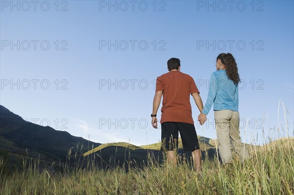 Rear view of couple holding hands, Utah, United States. Date : 2007