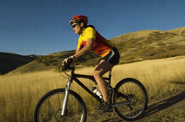 Woman riding mountain bike, Salt Flats, Utah, United States. Date : 2007