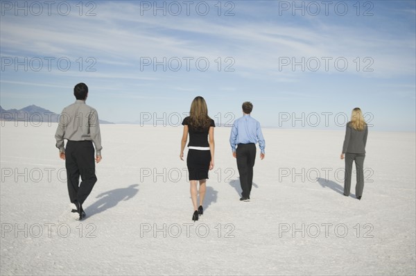 Businesspeople walking on salt flats, Salt Flats, Utah, United States. Date : 2007