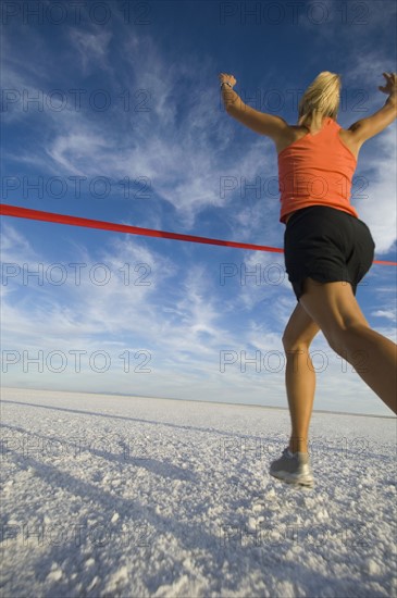 Woman running across finish line, Utah, United States. Date : 2007