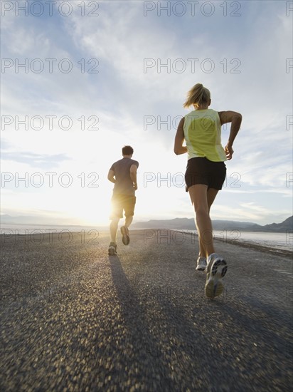 Couple running on road, Utah, United States. Date : 2007