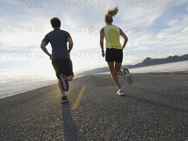 Couple running on road, Utah, United States. Date : 2007