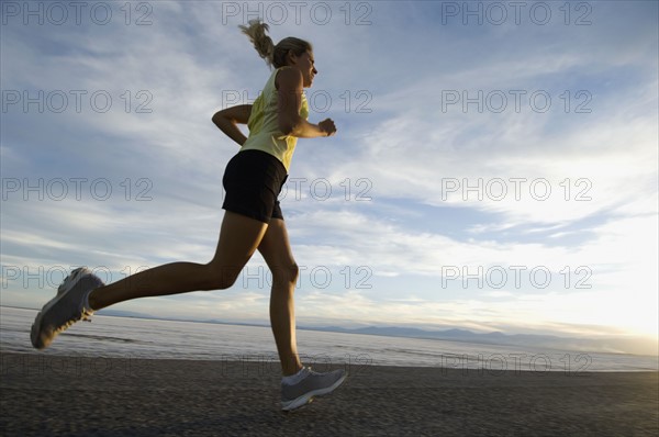 Woman running on road, Utah, United States. Date : 2007