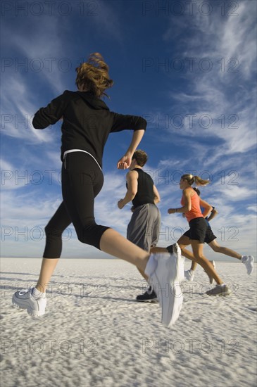 Group of people running on salt flats, Utah, United States. Date : 2007