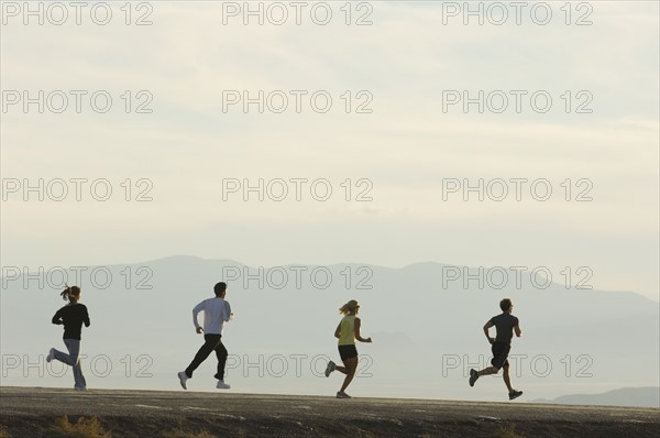 Group of people running on road, Utah, United States. Date : 2007