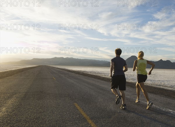 Couple running on road, Utah, United States. Date : 2007