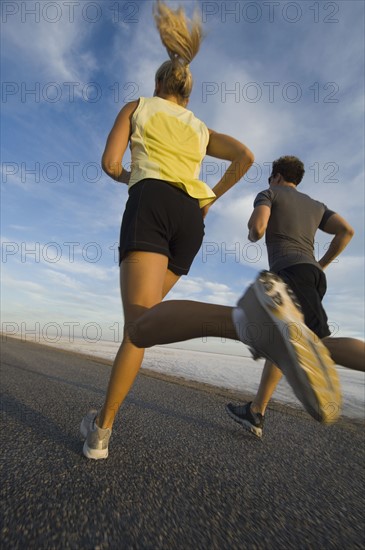 Couple running on road, Utah, United States. Date : 2007