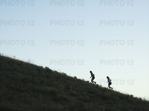 People running up mountain, Salt Flats, Utah, United States. Date : 2007