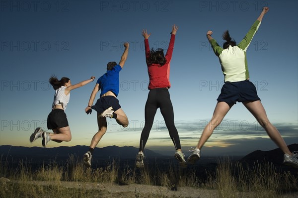 Rear view of people jumping, Salt Flats, Utah, United States. Date : 2007