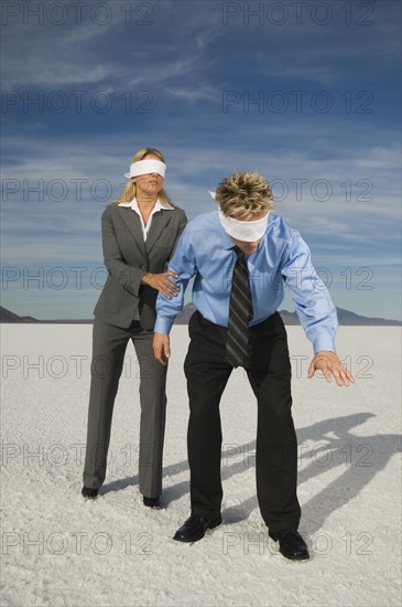Blindfolded businesspeople on salt flats, Salt Flats, Utah, United States. Date : 2007