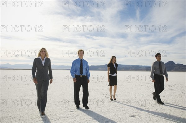 Businesspeople walking on salt flats, Salt Flats, Utah, United States. Date : 2007