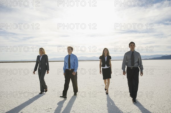 Businesspeople walking on salt flats, Salt Flats, Utah, United States. Date : 2007