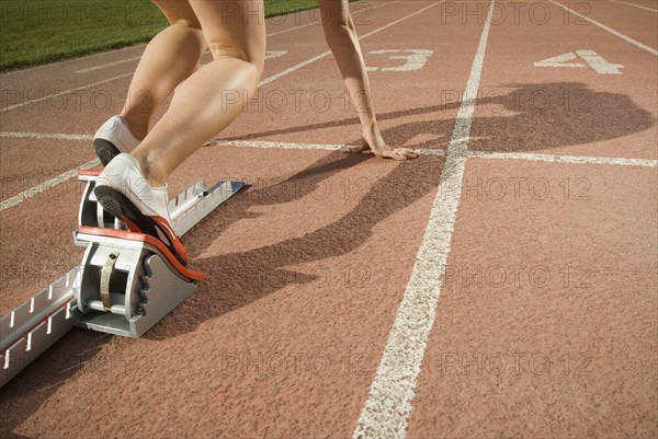 Female runner at starting block, Utah, United States. Date : 2007