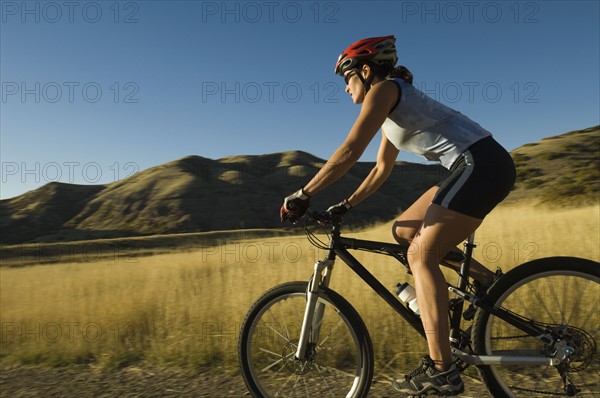 Woman riding mountain bike, Salt Flats, Utah, United States. Date : 2007
