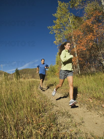 Couple jogging on trail, Utah, United States. Date : 2007