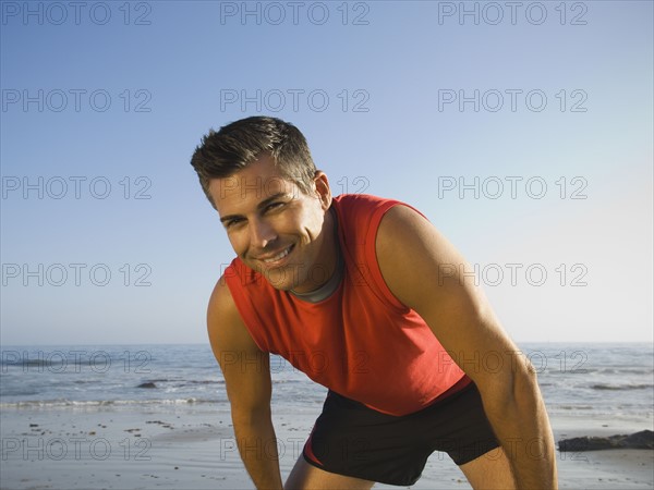 Man in athletic gear at beach. Date : 2007