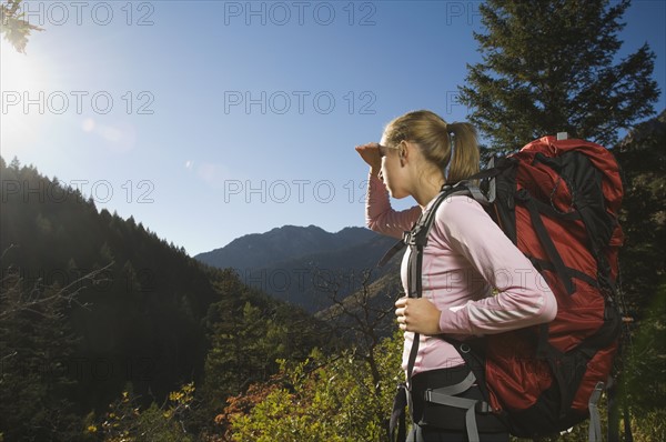 Female hiker shielding eyes with hand, Utah, United States. Date : 2007