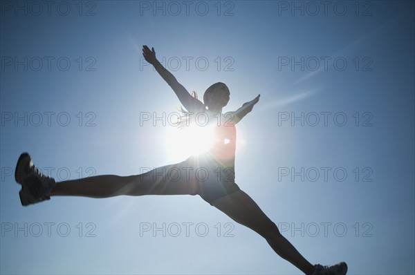 Low angle view of woman jumping. Date : 2007