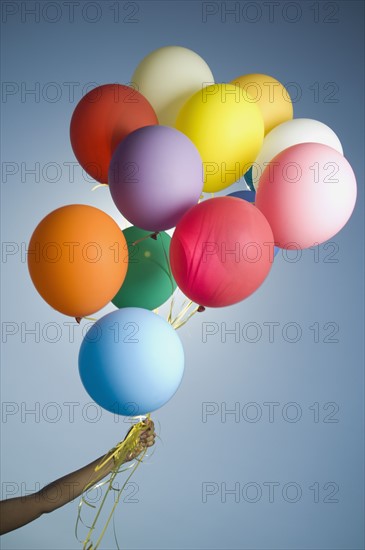 Woman holding bunch of balloons. Date : 2007