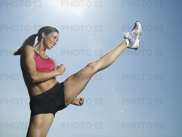 Woman in athletic gear kicking. Date : 2007