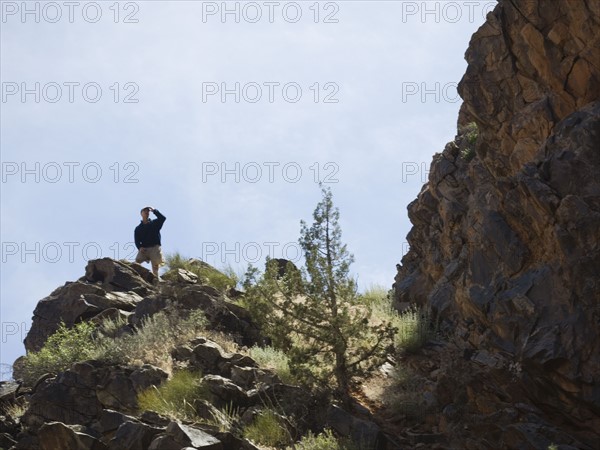 Man standing on cliff. Date : 2007