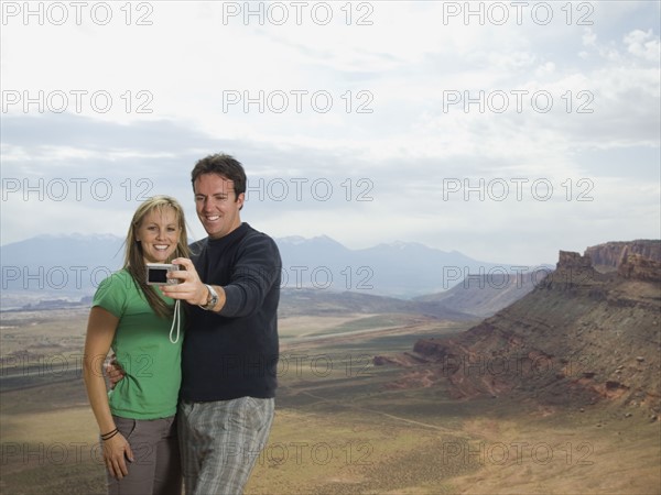 Couple taking own photograph. Date : 2007