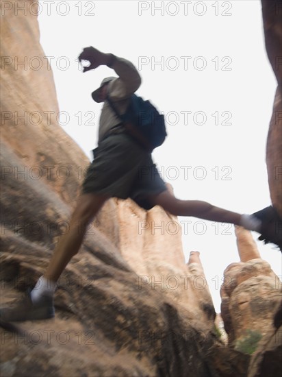 Man jumping over rock formations. Date : 2007