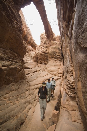 People looking up at rock formations. Date : 2007