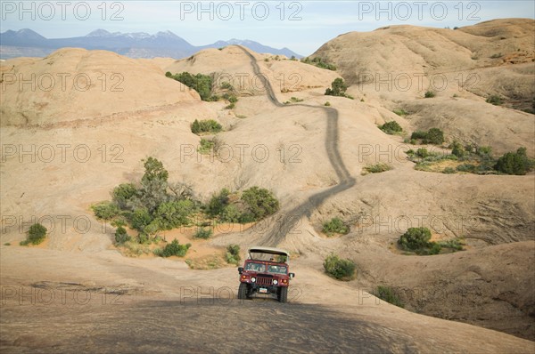 Off-road vehicle driving on rock formation. Date : 2007