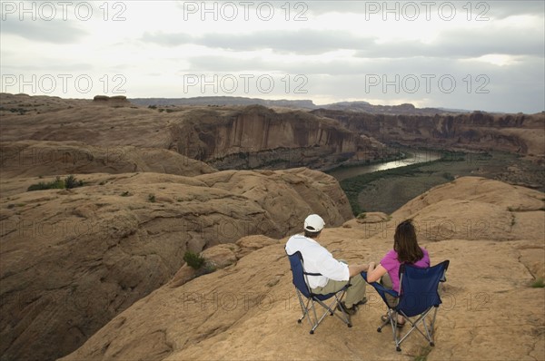Couple in camping chairs over-looking canyon. Date : 2007