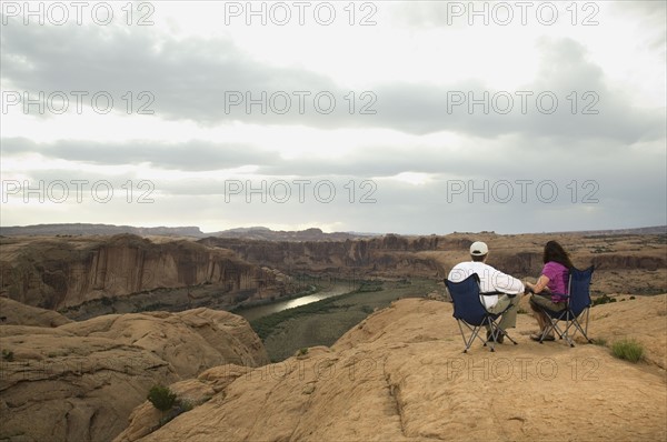 Couple in camping chairs over-looking canyon. Date : 2007