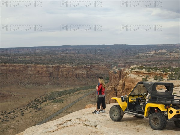 Couple looking over edge of cliff. Date : 2007