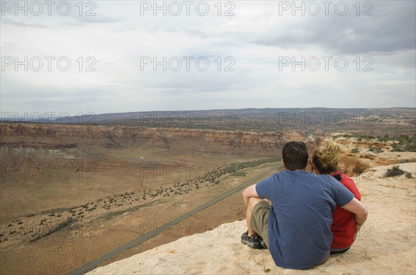 Couple looking over edge of cliff. Date : 2007