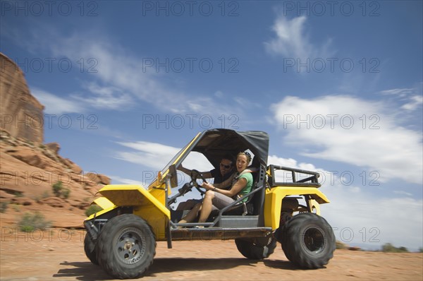 Woman driving off-road vehicle in desert. Date : 2007