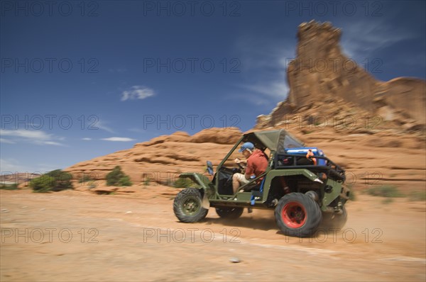 Man driving off-road vehicle in desert. Date : 2007