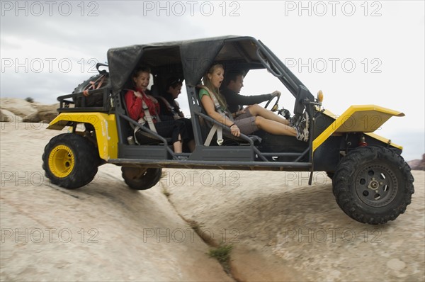 People in off-road vehicle on rock formation. Date : 2007