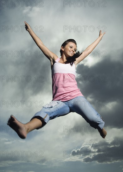 Low angle view of woman jumping. Date : 2007