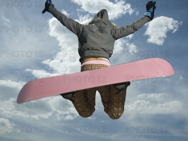 Low angle view of snowboarder jumping. Date : 2007