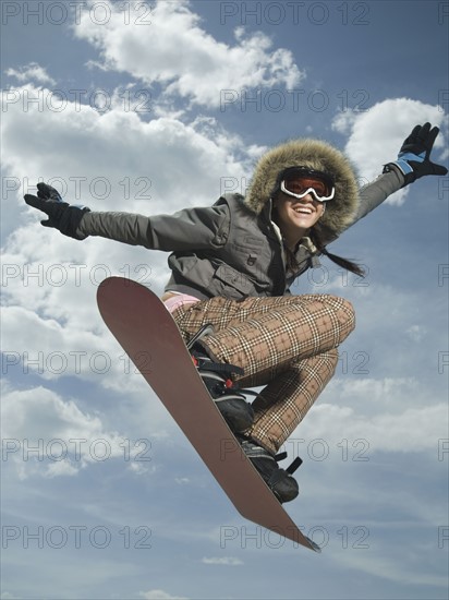 Low angle view of snowboarder jumping. Date : 2007