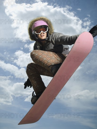 Low angle view of snowboarder jumping. Date : 2007