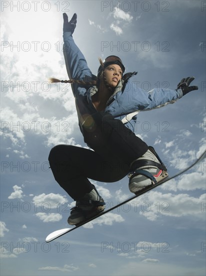 Low angle view of snowboarder jumping. Date : 2007