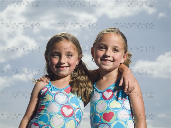 Two young sisters hugging. Date : 2007