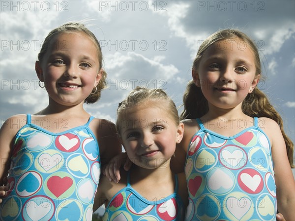 Three young sisters hugging. Date : 2007