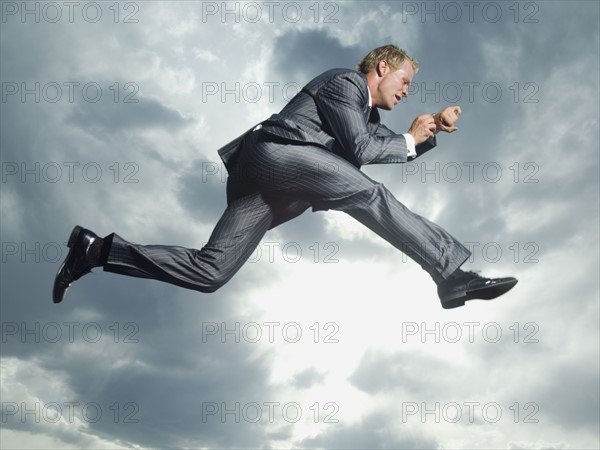 Low angle view of businessman jumping. Date : 2007