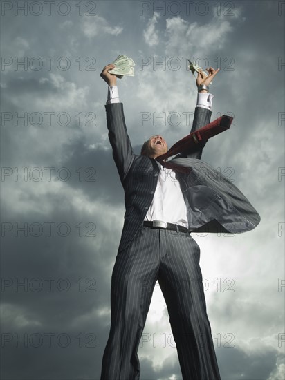 Low angle view of businessman cheering. Date : 2007
