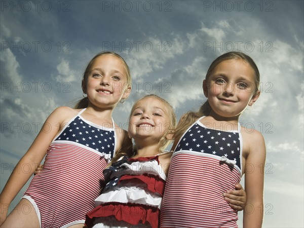 Three young sisters hugging. Date : 2007