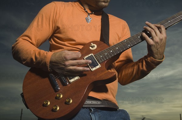 Close up of man playing guitar. Date : 2007