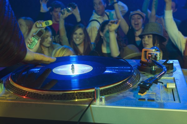 Crowd cheering for DJ. Date : 2007