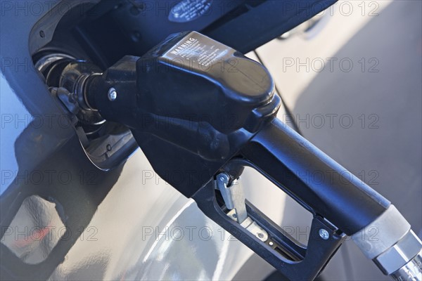 pumping gas in a car. Date : 2007