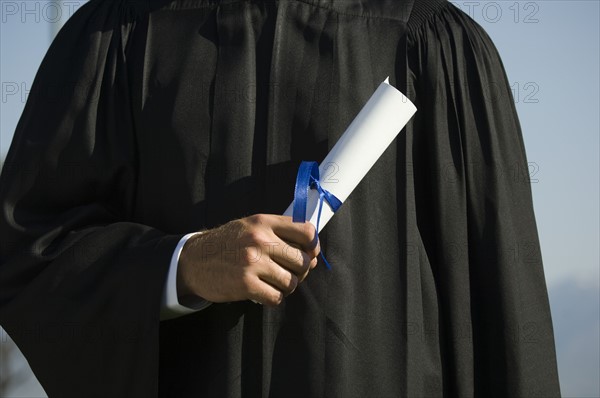Male graduate holding diploma. Date : 2007